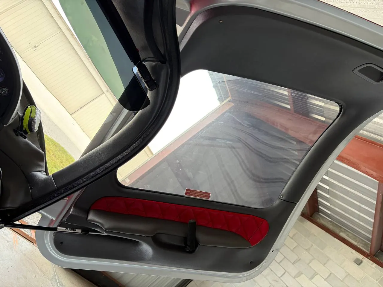 Red diamond-stitched aircraft door panel insert by GVO Classic Upholstery