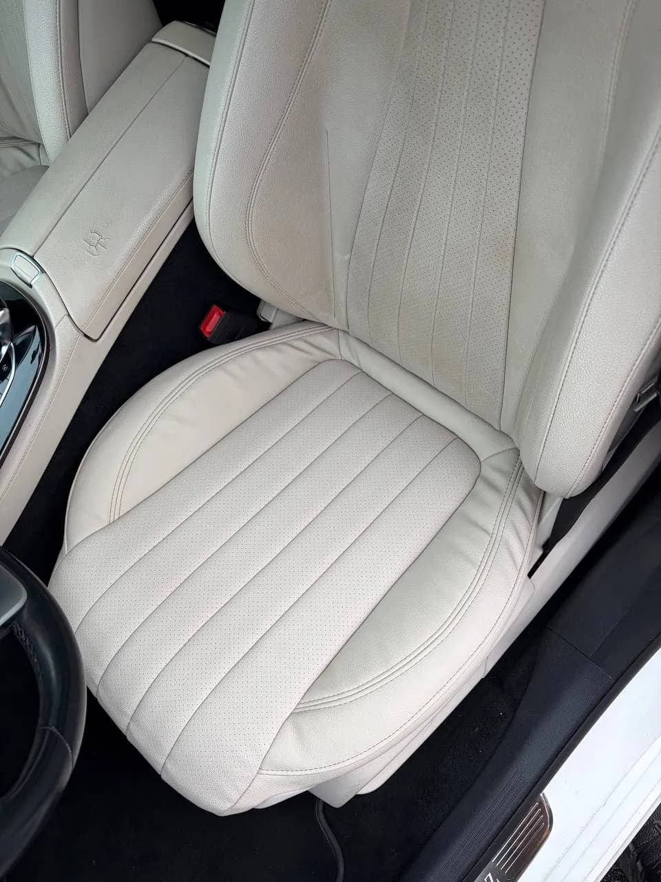 Rebuilt cream leather car seat installed back in the vehicle, North Port FL