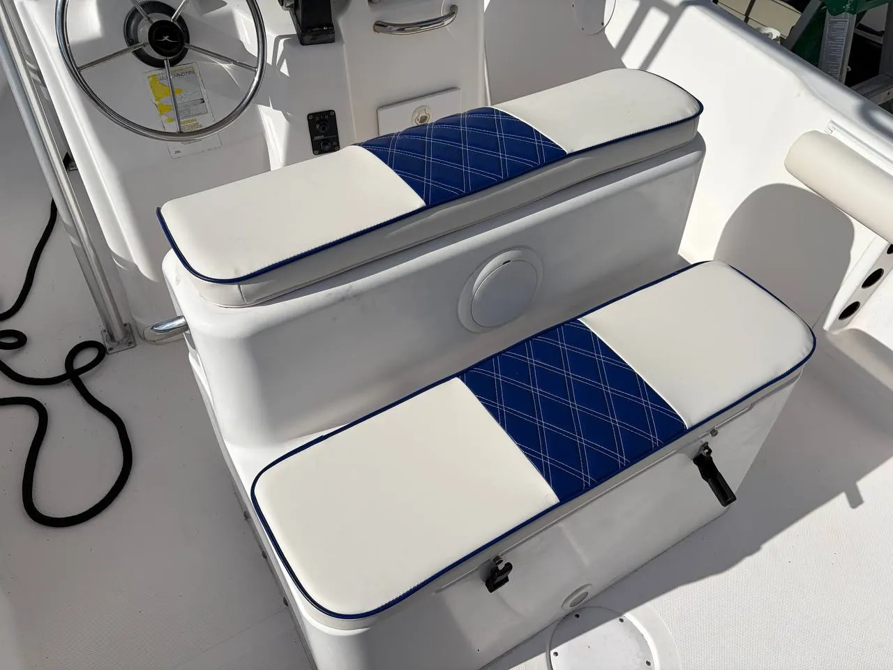 White and blue center console boat with rebuilt helm bench and bolsters