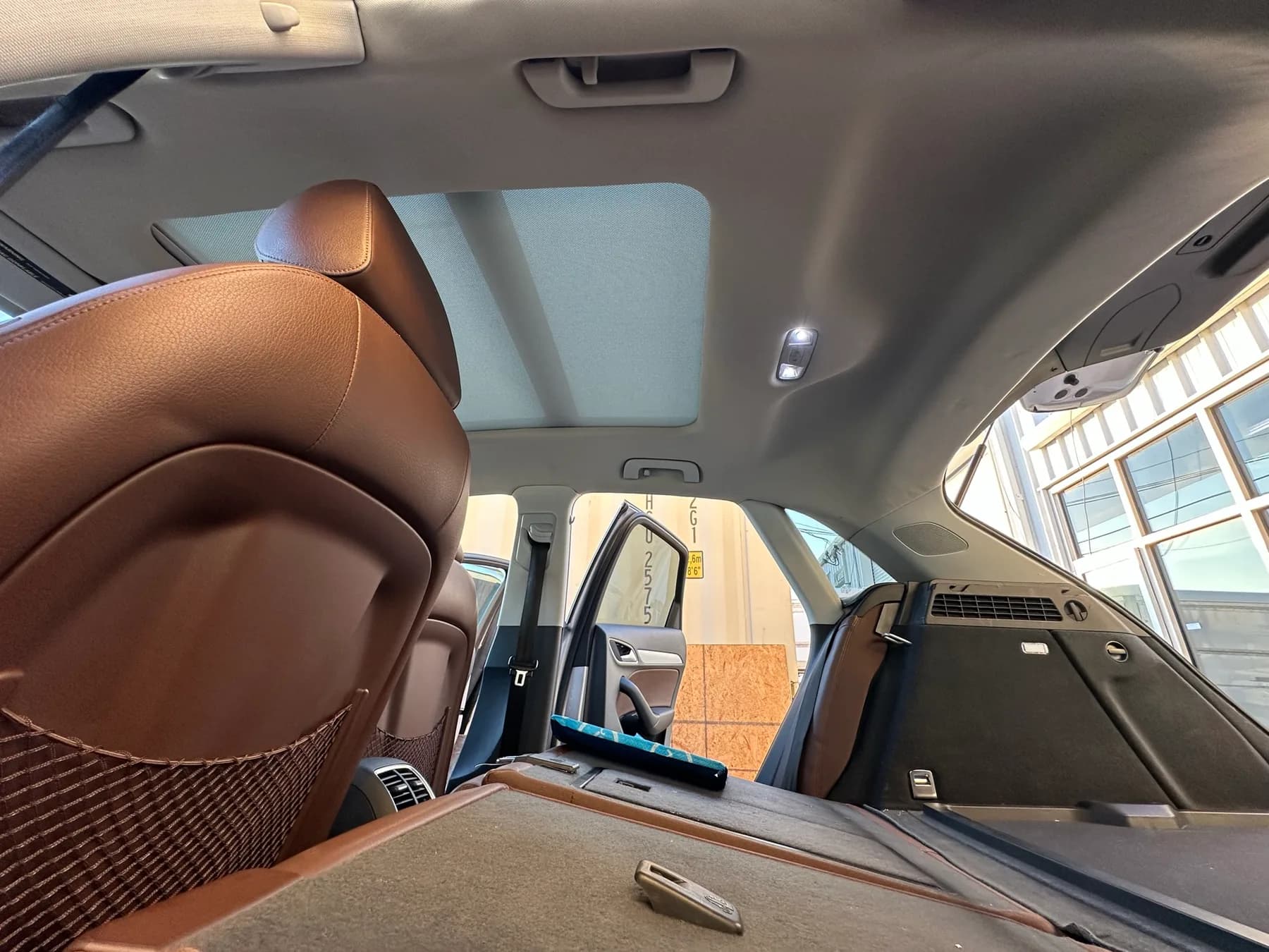 Brown leather auto interior with a new headliner installed